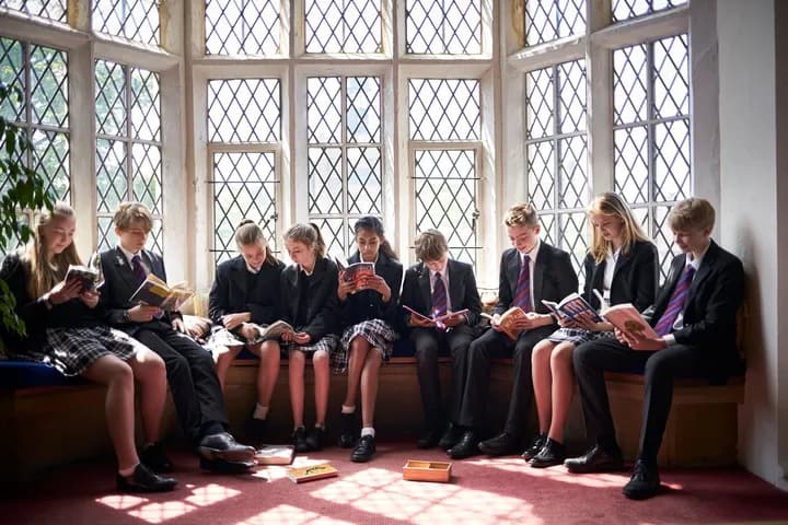 Students reading in the library window seat