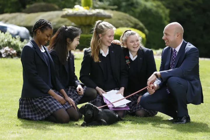 Students on the lawn with a teacher
