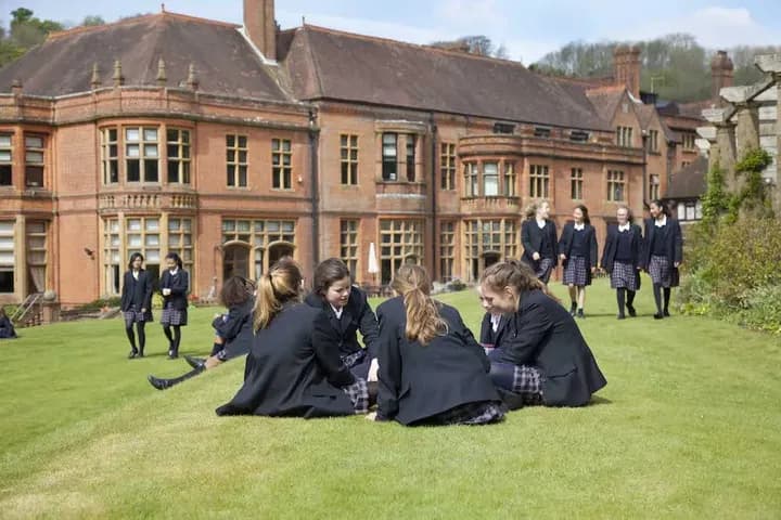 Students relaxing outside the main house